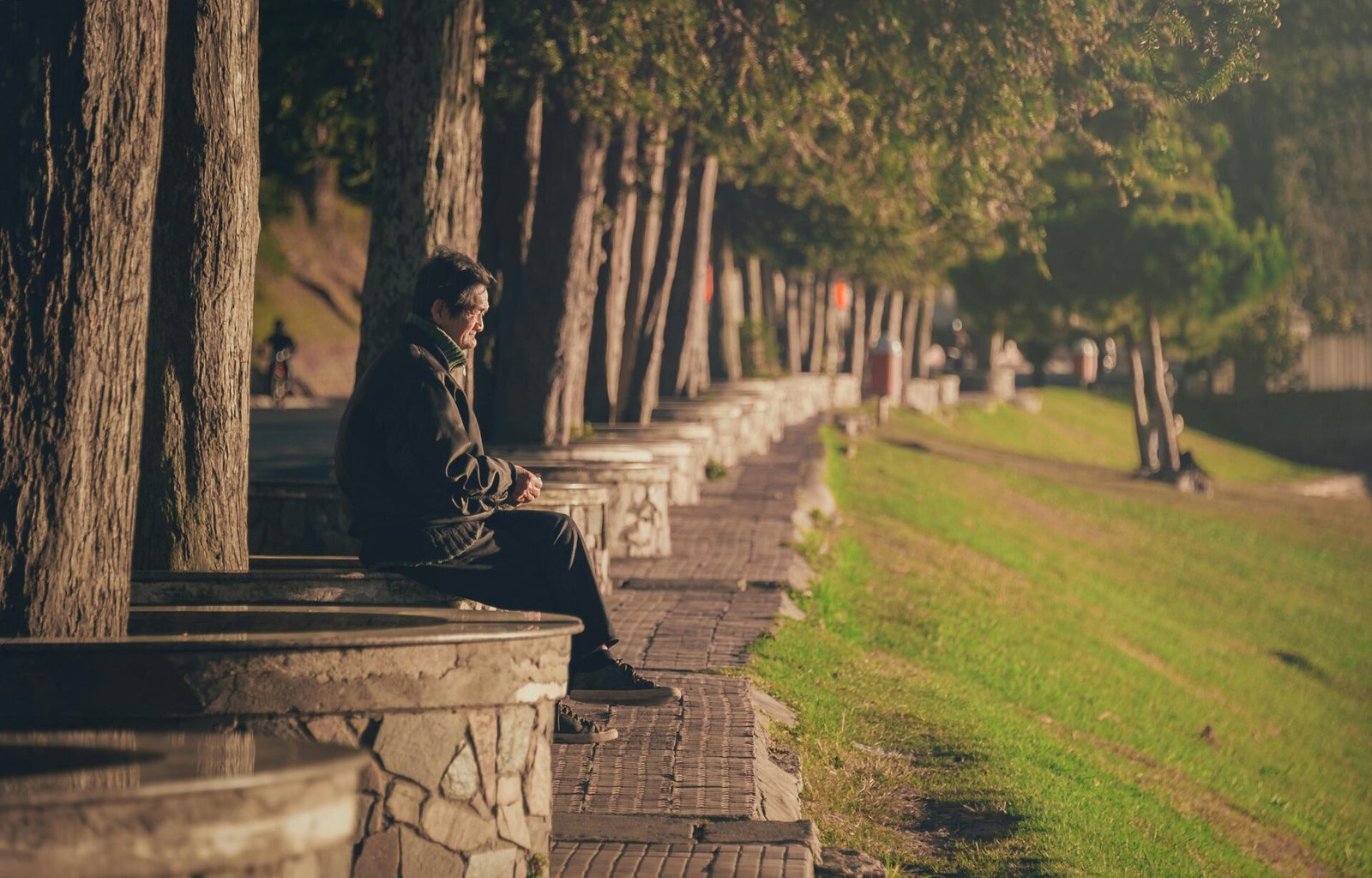man relaxing on a column at the lake